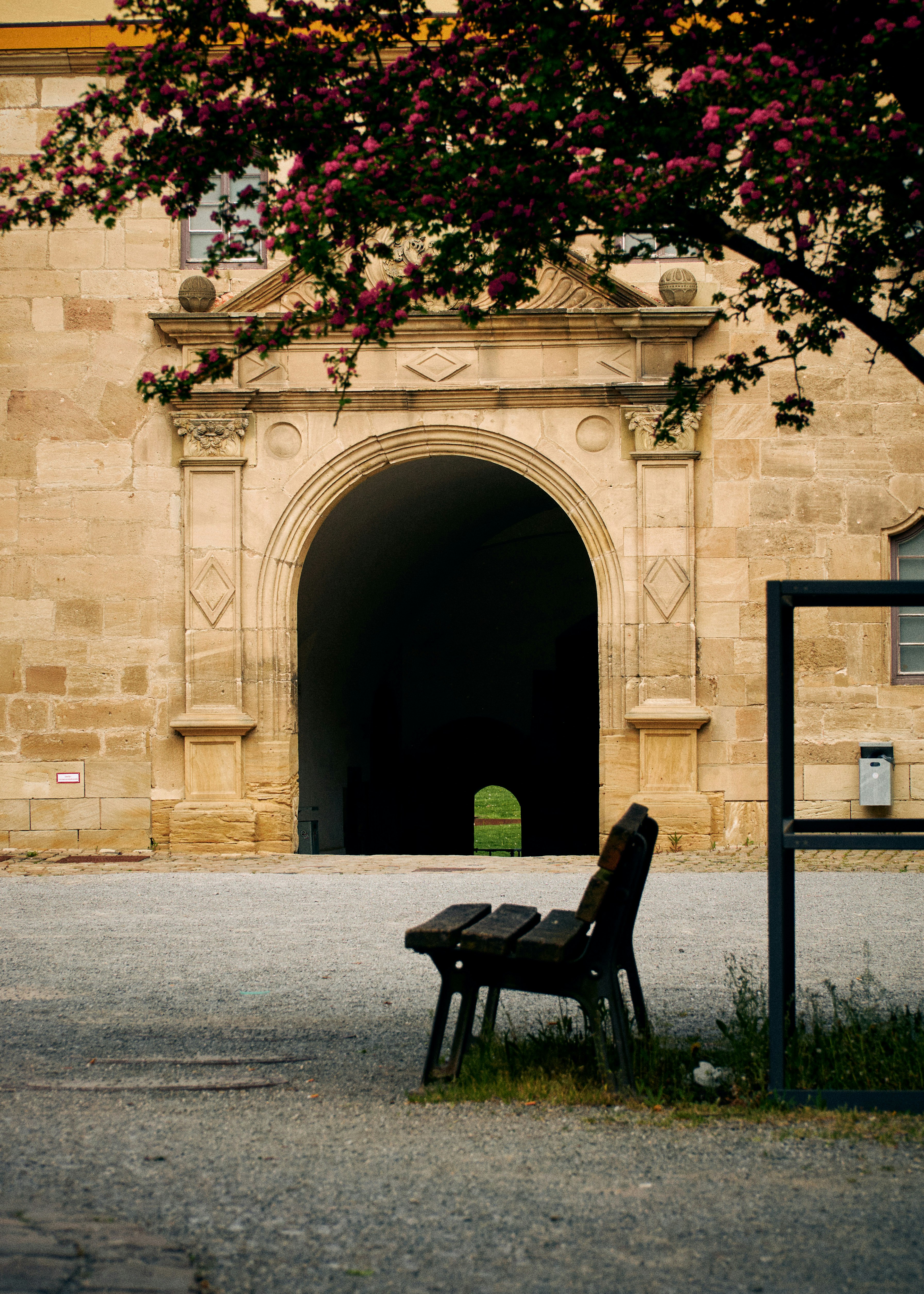 black wooden bench near brown concrete building